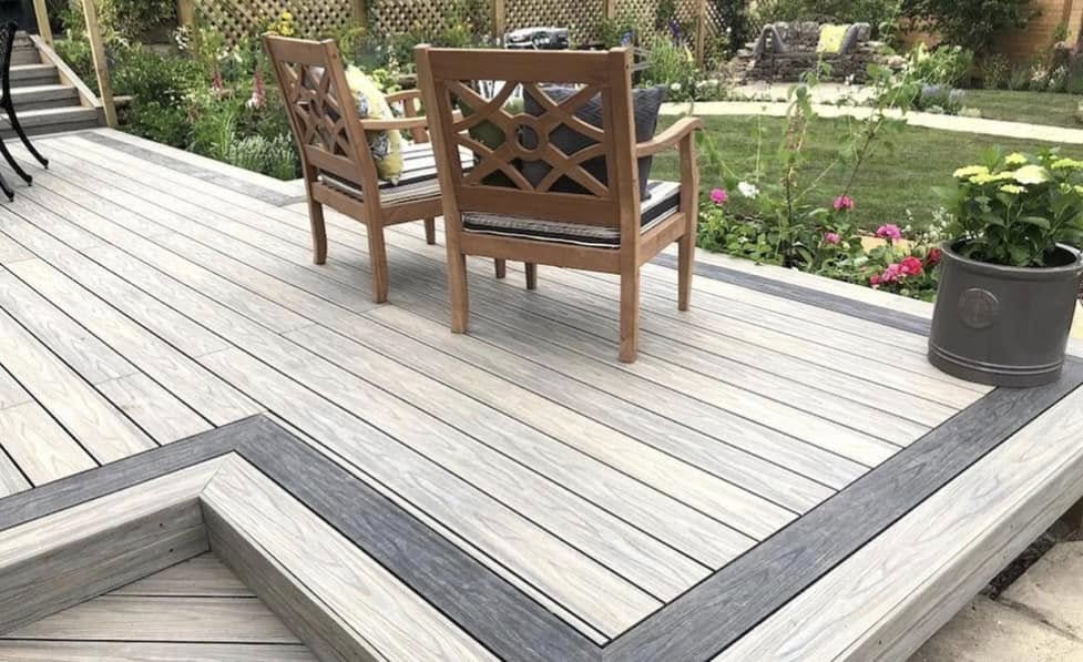 Composite decking installation in silver grey with contrasting border by Glorious Gardens Son & Co.