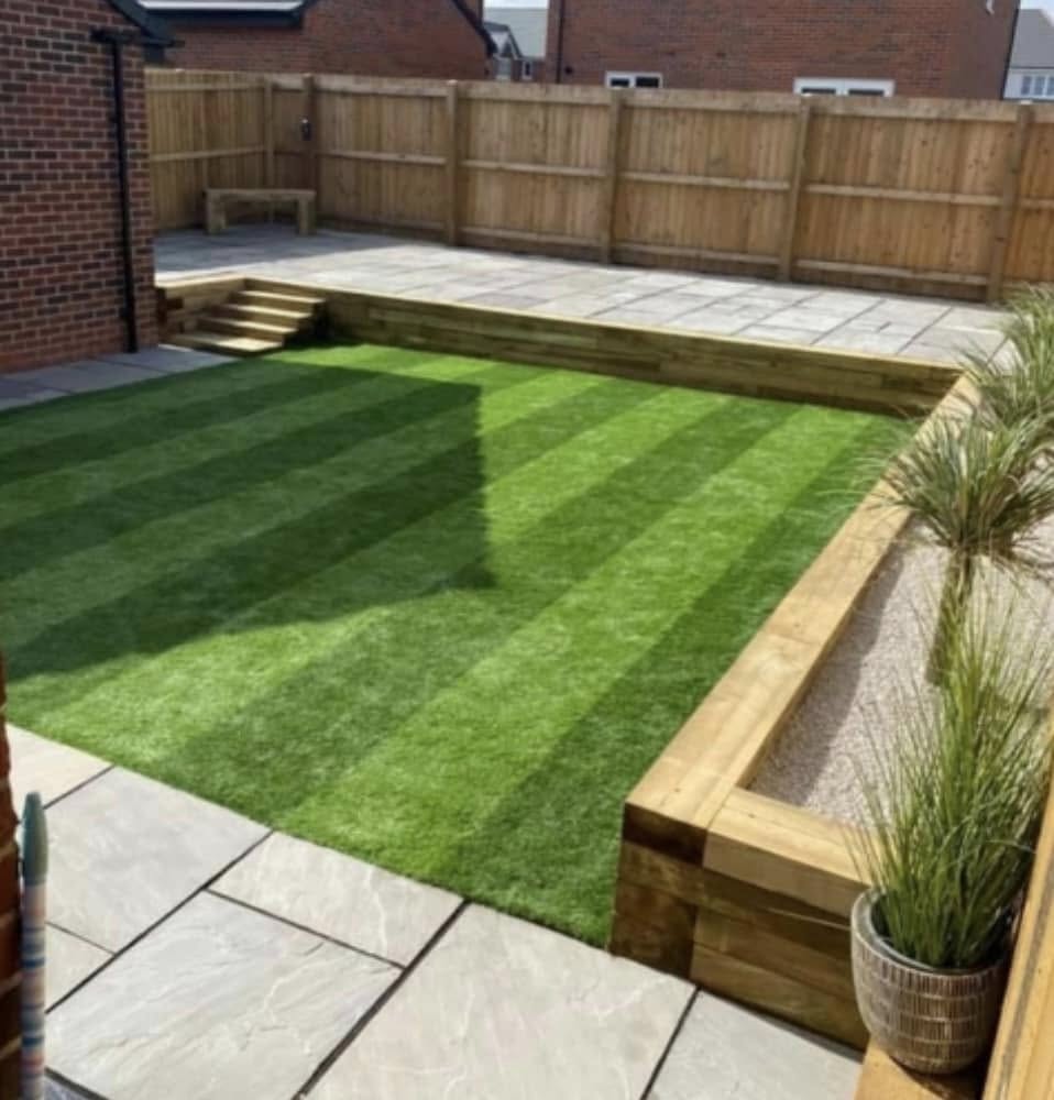 Two-level garden with raised lawn and timber sleeper raised beds by Glorious Gardens Son & Co.